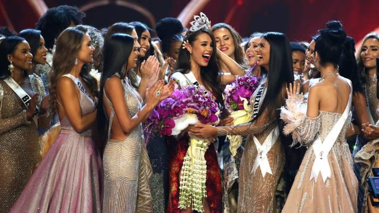 Contestants congratulate new Miss Universe Catriona Gray, center, from Philippines during the final round of 67th Miss Universe competition in Bangkok, Thailand, Monday, Dec. 17, 2018.(AP Photo/Gemunu Amarasinghe)