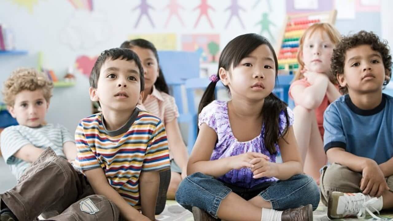 Children sitting on a floor