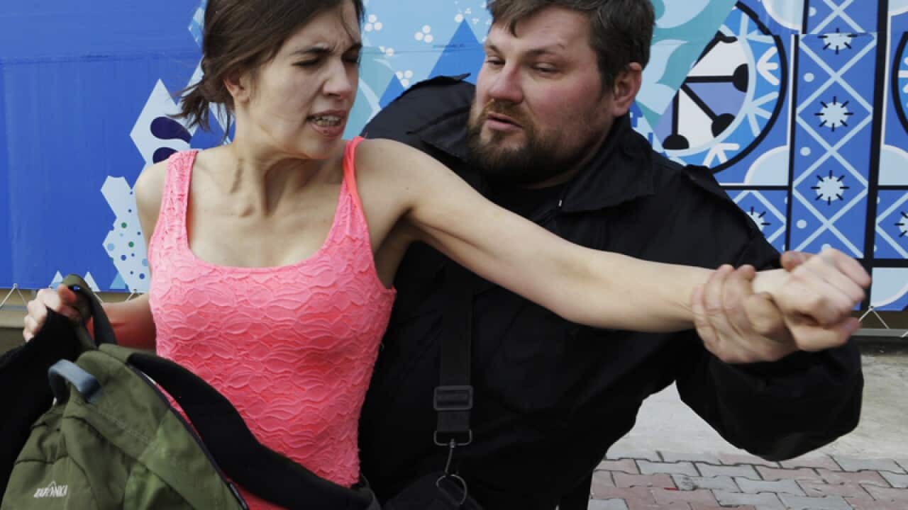 A member of Pussy Riot is attacked by Cossack militia