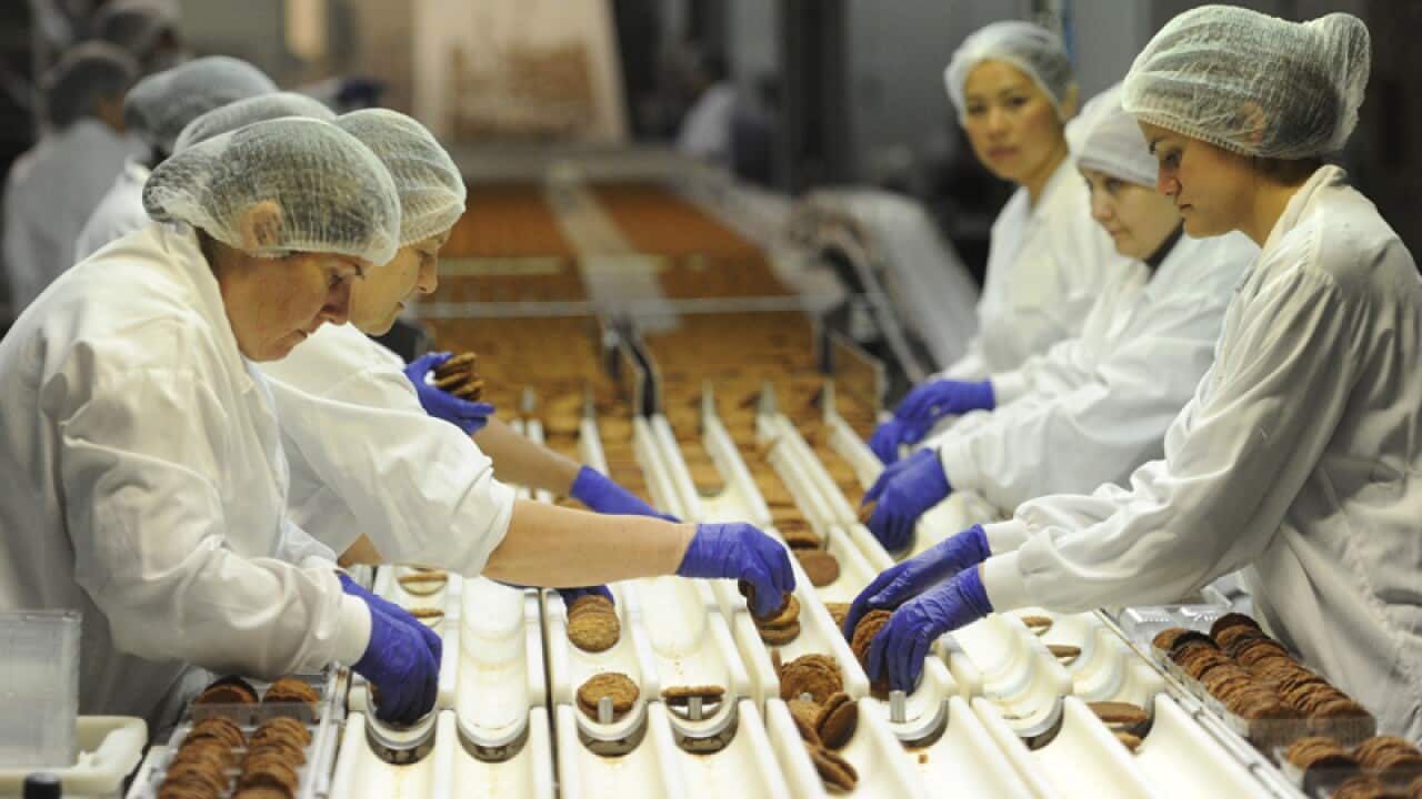 Employees work at the Modern Baking Company factory in Melbourne