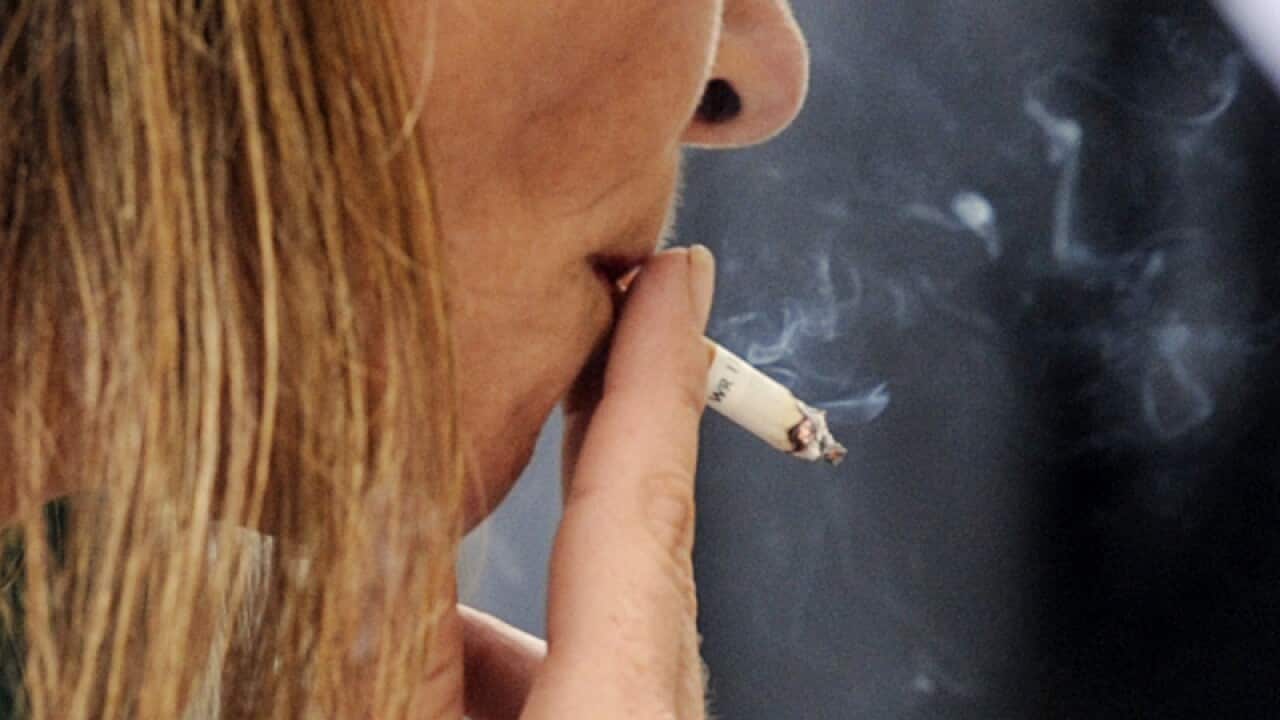 A woman smokes a cigarette in Brisbane.