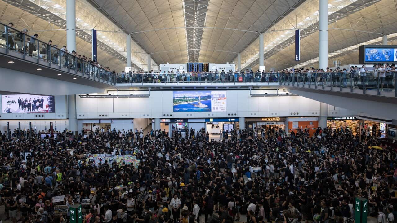 Anti-extradition bill protesters take part in a rally inside the arrivals hall of Hong Kong International Airport.