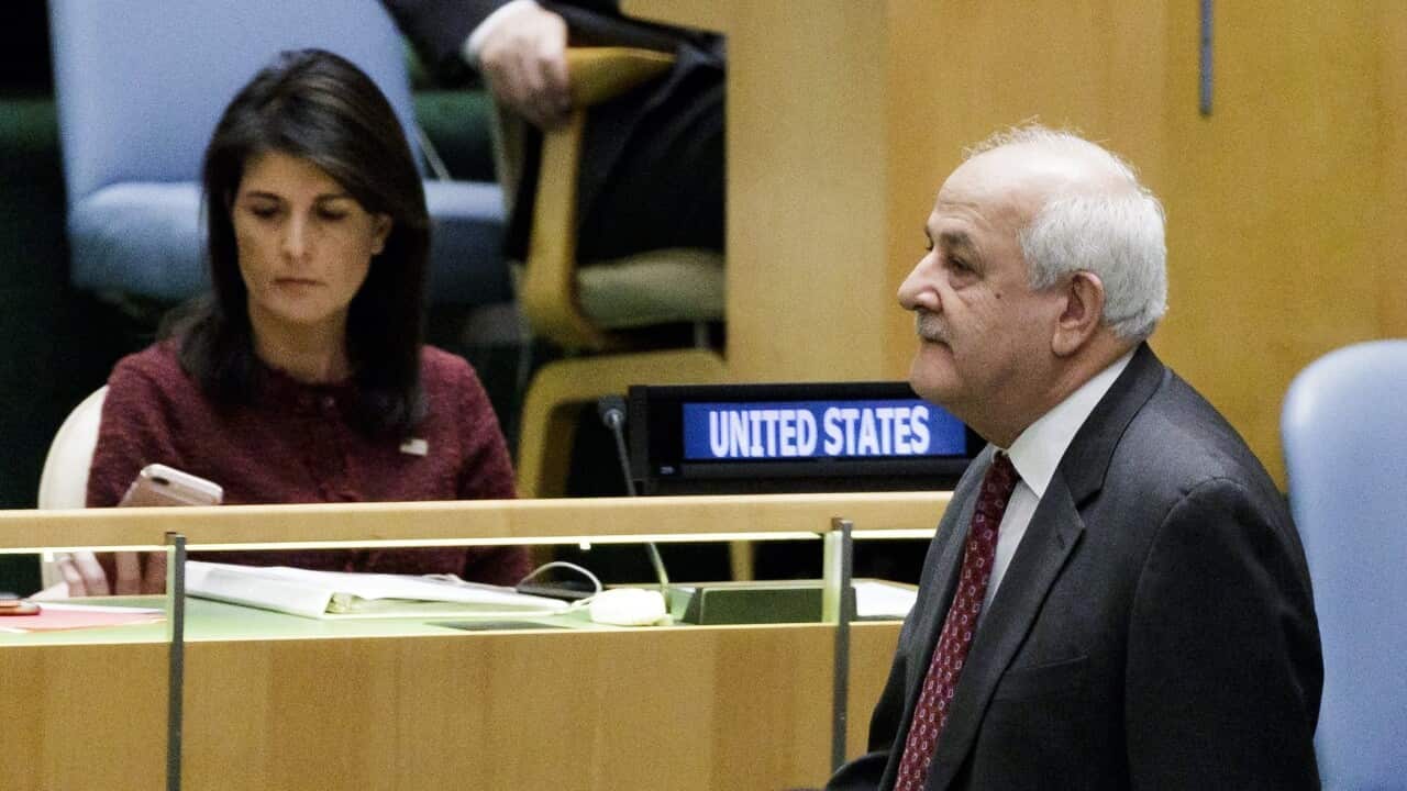 Riyad Mansour, Palestine's Permanent Observer to the United Nations, walks past United States' Ambassador to the United Nations Nikki Haley