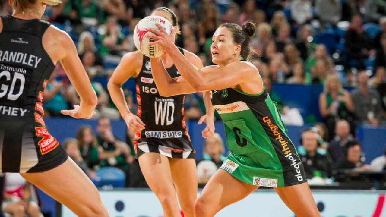 Verity Charles of the Fever (in green) during Round 2 of the Super Netball