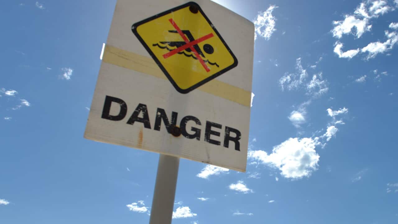 Warning sign near water