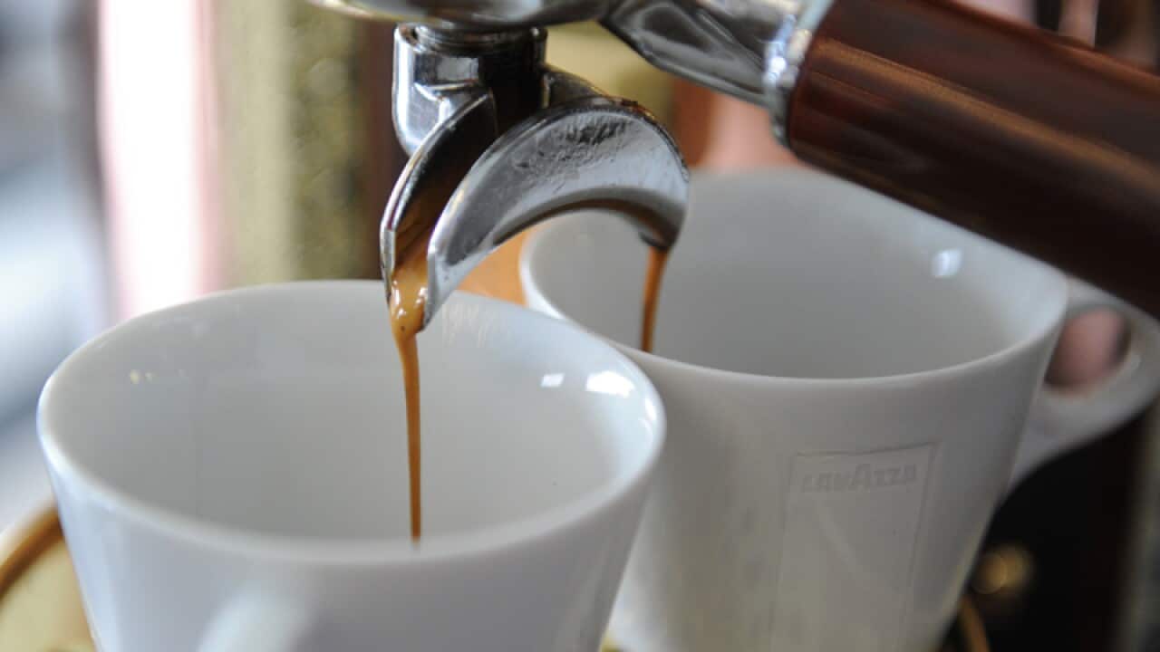 Coffee pours into cups in a cafe