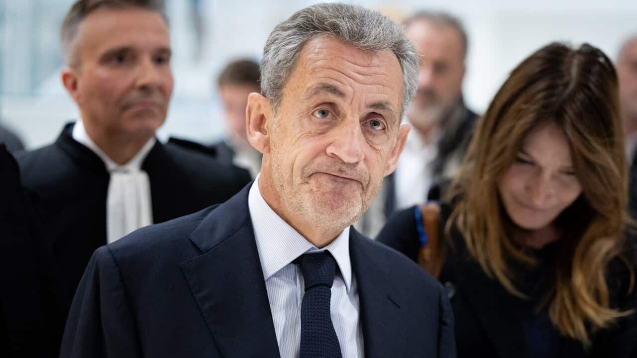 Former French president Nicolas Sarkozy in a navy suit