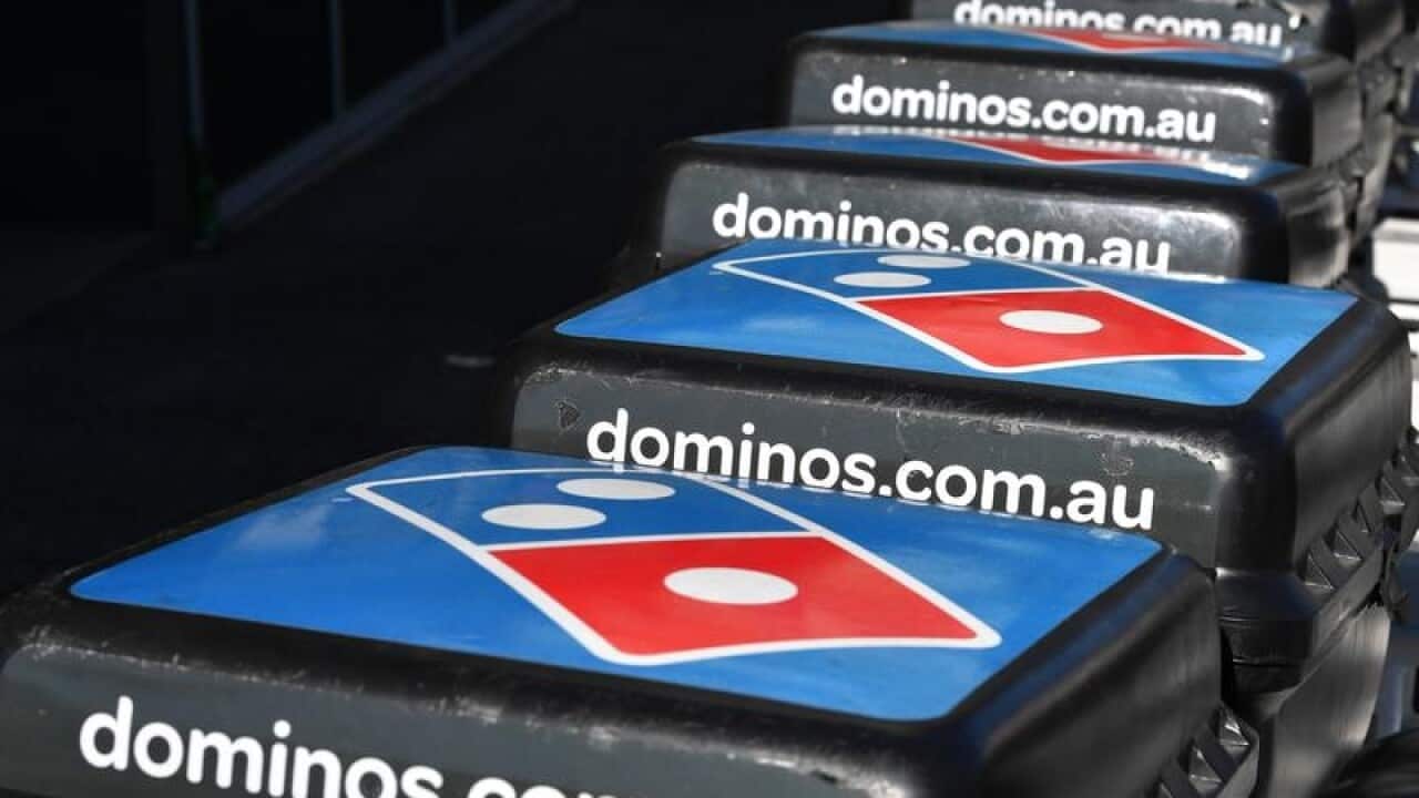 Domino's Pizza delivery bikes are seen outside a Domino's store.