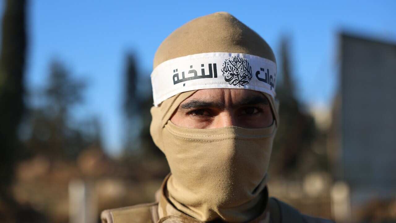 An opposition fighter patrols on a street in Aleppo, Syria, 30 November 2024,