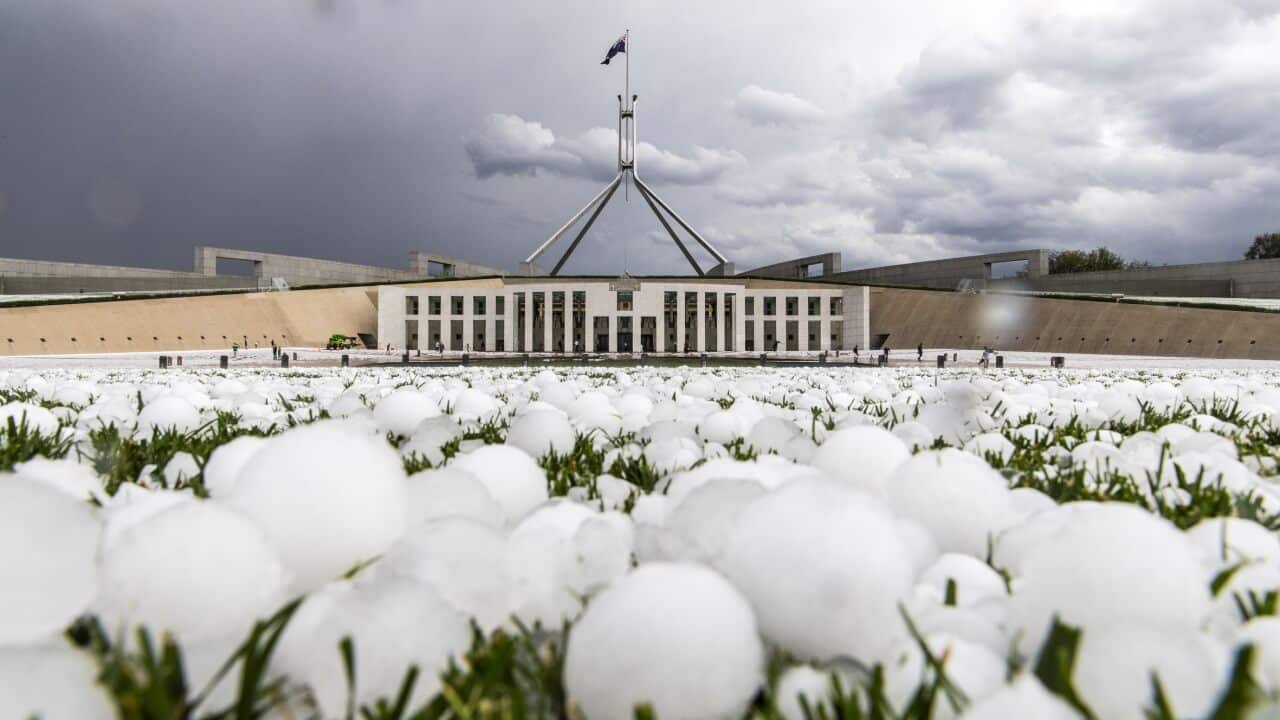 Huge hailstones cover the Parliament House forecourt. 