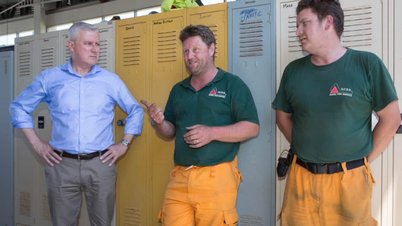 DeputyPrime MinisterMichael McCormack (left) meets Queensland Fire and Emergency Services crew members