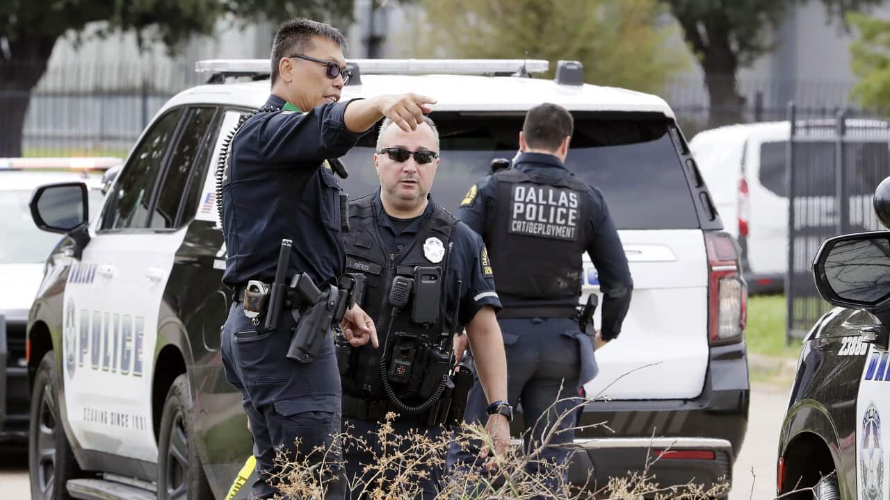 Dallas Police investigate the scene where a shooter opened fire on a U.S. Immigration and Customs Enforcement facility