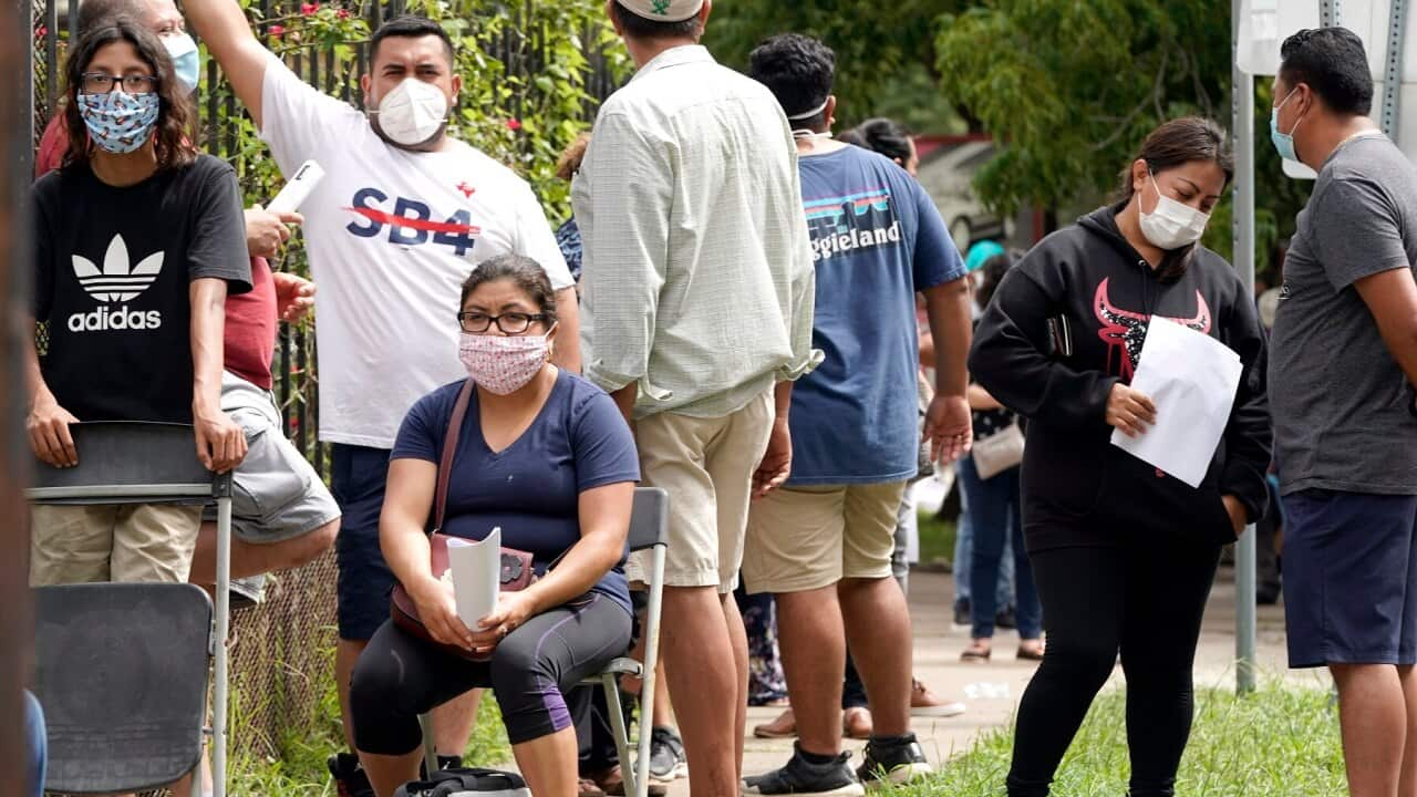 People wait in line at a free COVID-19 testing site in Houston, Texas