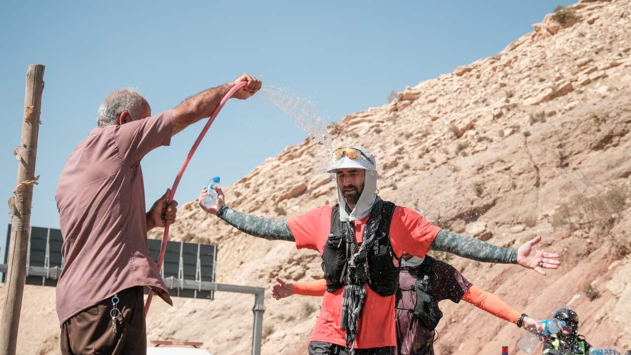 Tim Buxton getting sprayed with water in Shaqlawa during his marathon.jpg