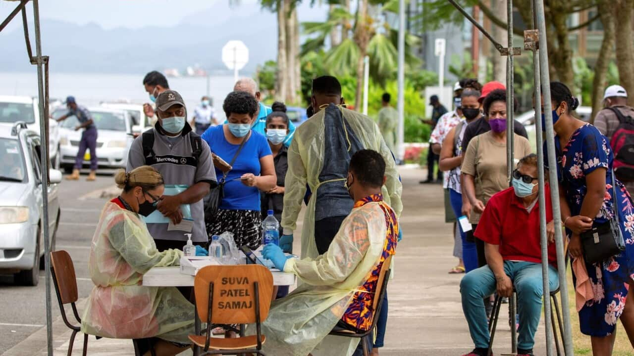 Residents queue up for their vaccine dose outside a vaccination centre in Suva.