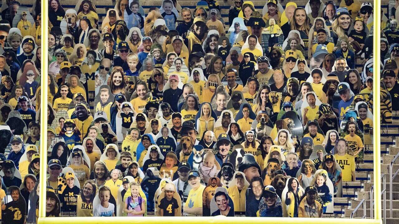 Cardboard cutouts of people sit in the stands in Michigan Stadium at the football game between Michigan and Wisconsin on November 14, 2020. Attendance at games was limited amid the COVID-19 pandemic. (Photo by Dominick Sokotoff/Sipa USA)