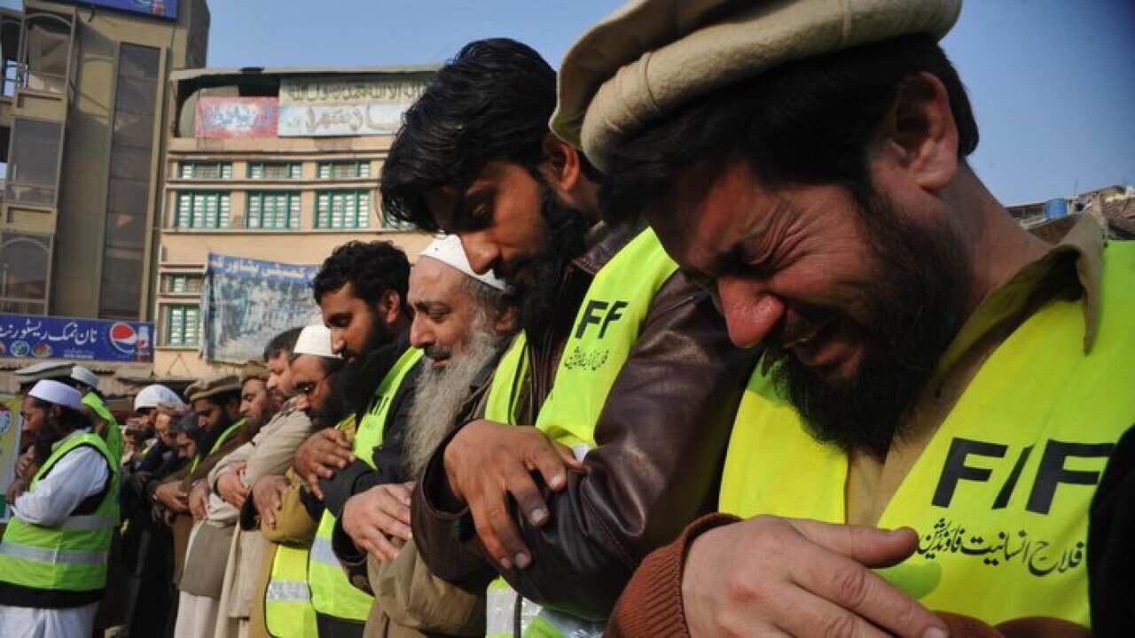 Pakistani Muslims offer prayers during a funeral ceremony.