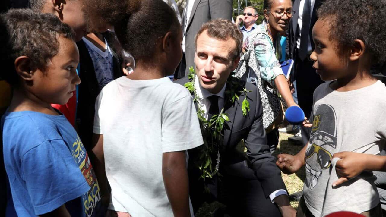 French President Emmanuel Macron speaks with children in New Caledonia on May 5, 2018.