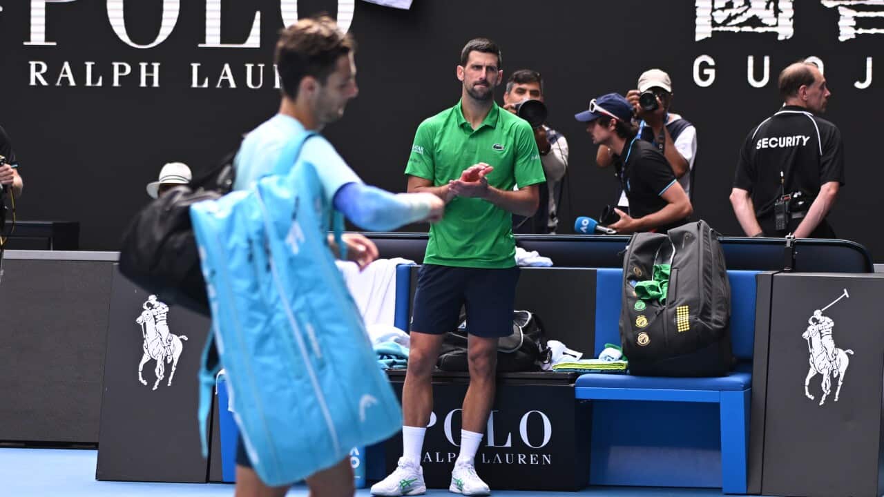 Serbia's Novak Djokovic applauds Lorenzo Musetti of Italy as he leaves the court after retiring from their Australian Open quarterfinals with injury, at Melbourne Park on January 28, 2026