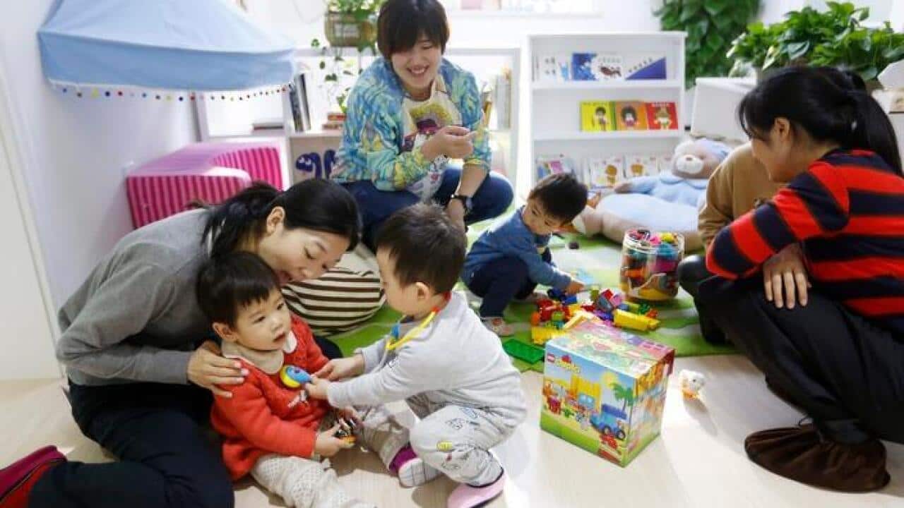 Mothers and children at play in China.