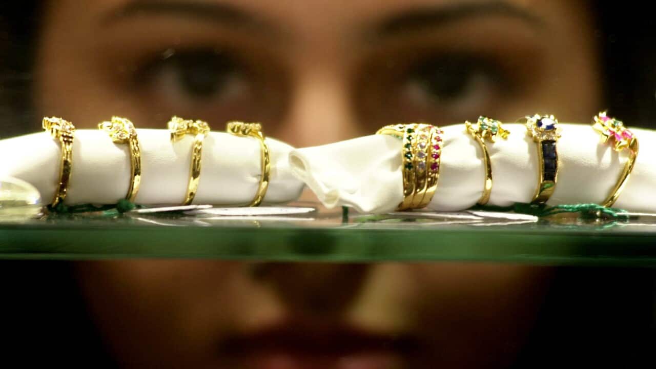 An Indian girl checks out precious stones studded gold rings, at the Gem &Jewellery Show 2001, in Bombay Saturday Sept. 29, 2001. T