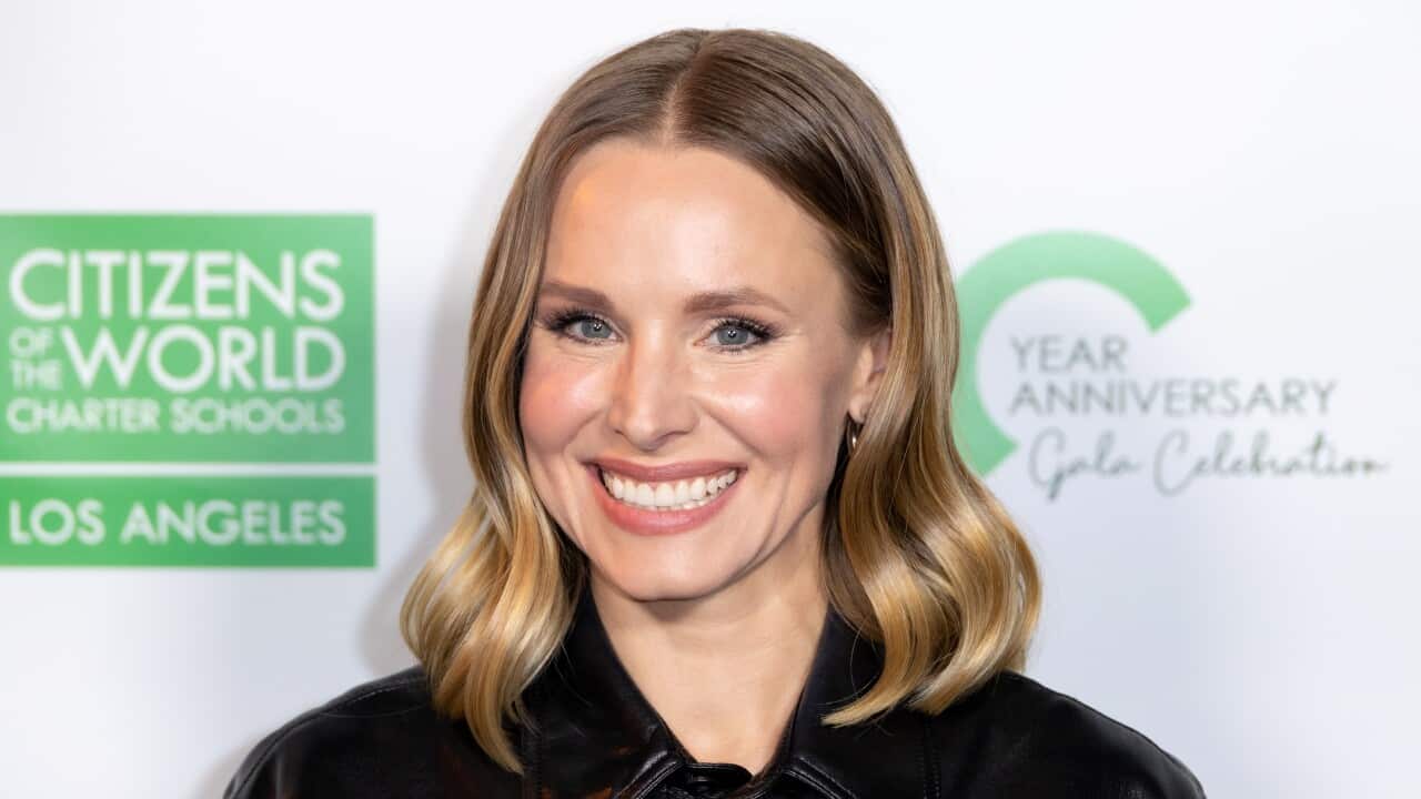 A woman with blonde hair smiling for a photo.