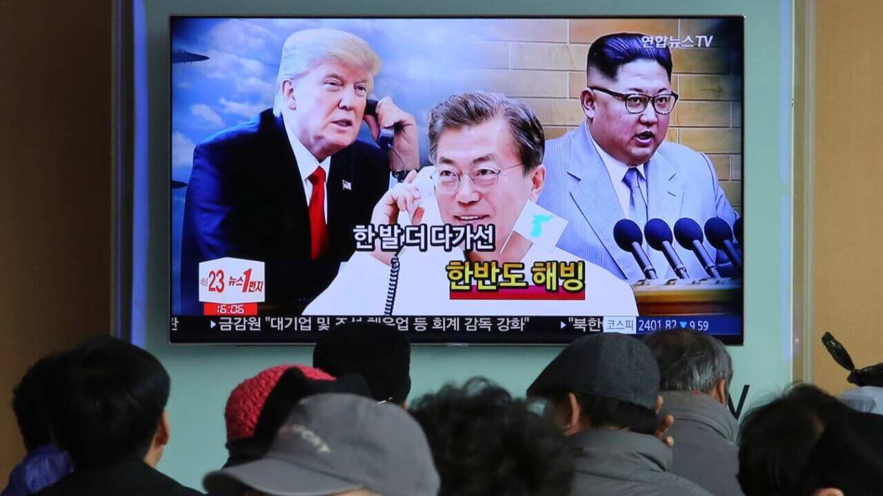 TV screen showing images of North Korean leader Kim Jong Un, right, South Korean President Moon Jae-in, center, and U.S. President Donald Trump 