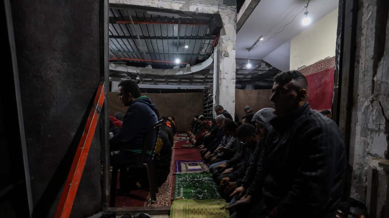 Palestinians say Tarawih prayers in the rubble of Al-Huda Mosque in Rafah (Getty).