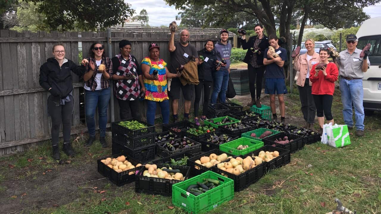 Harvest of Hope Community Garden volunteers with their fresh, seasonal produce.