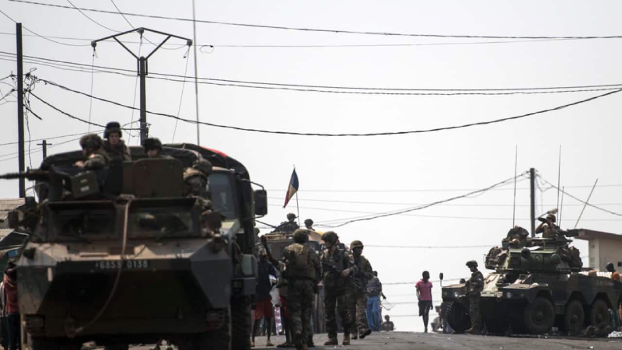 French troops man a position with light armoured vehicles