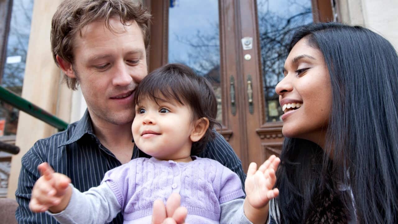 parents-sitting-on-front-stoop-with-baby-girl