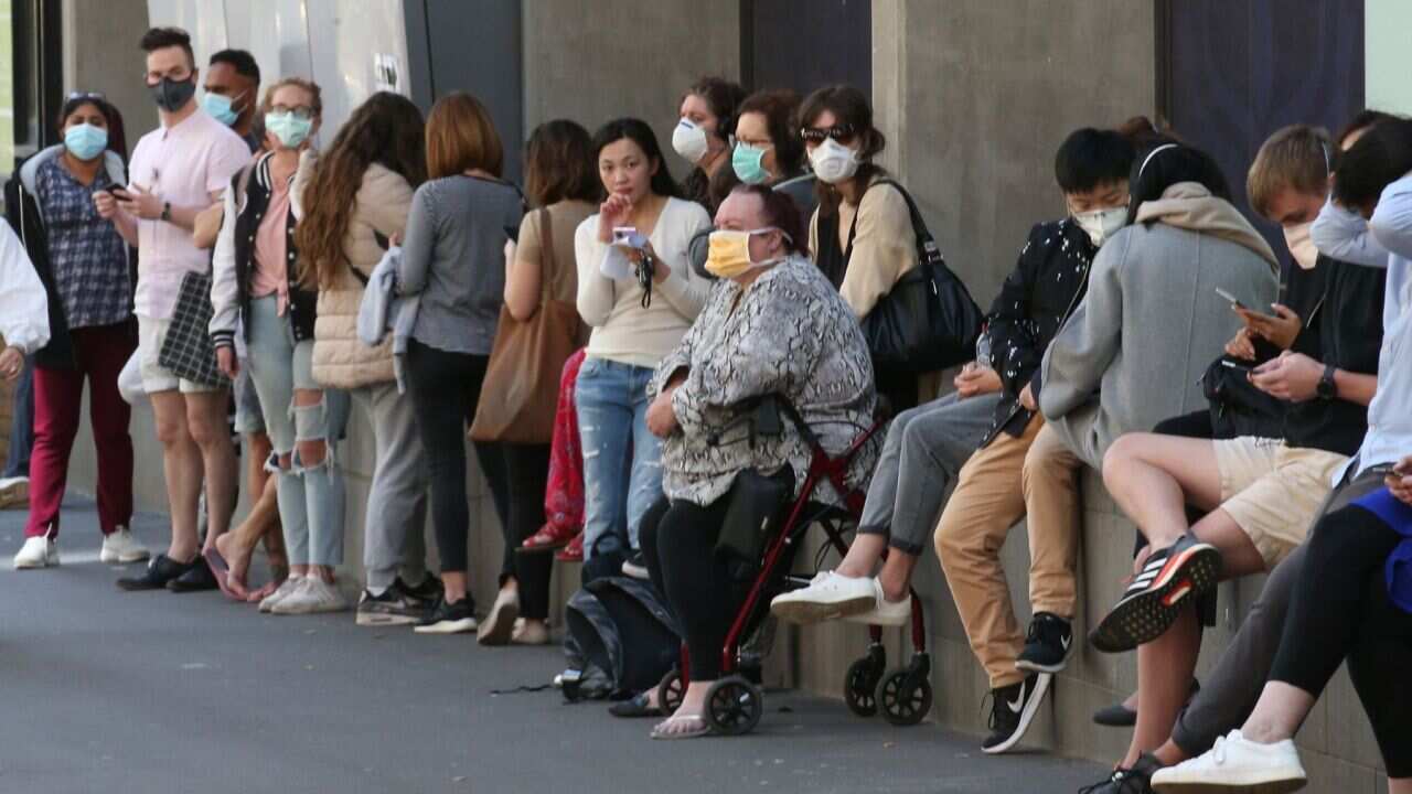 People line up outside the Royal Melbourne Hospital for coronavirus testing in Melbourne, Tuesday, March 10, 2020