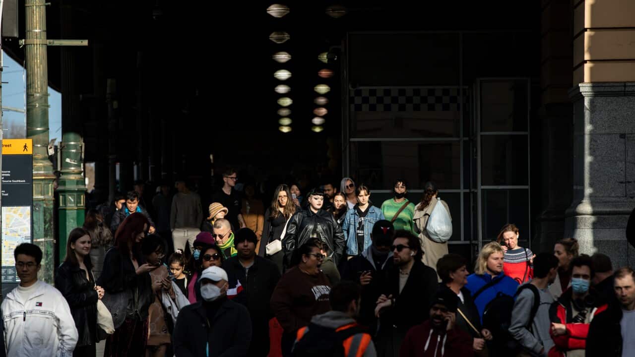 A crowd of people outside a train station