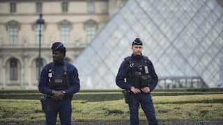 Police stand guard outside the Louvre museum in Paris