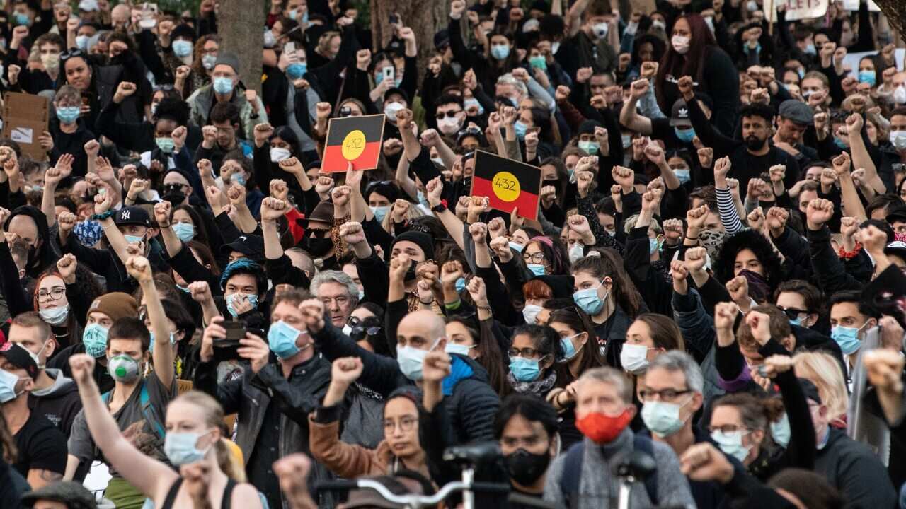 Thousands of protesters kneel at a Black Lives Matter rally in Sydney on Saturday.