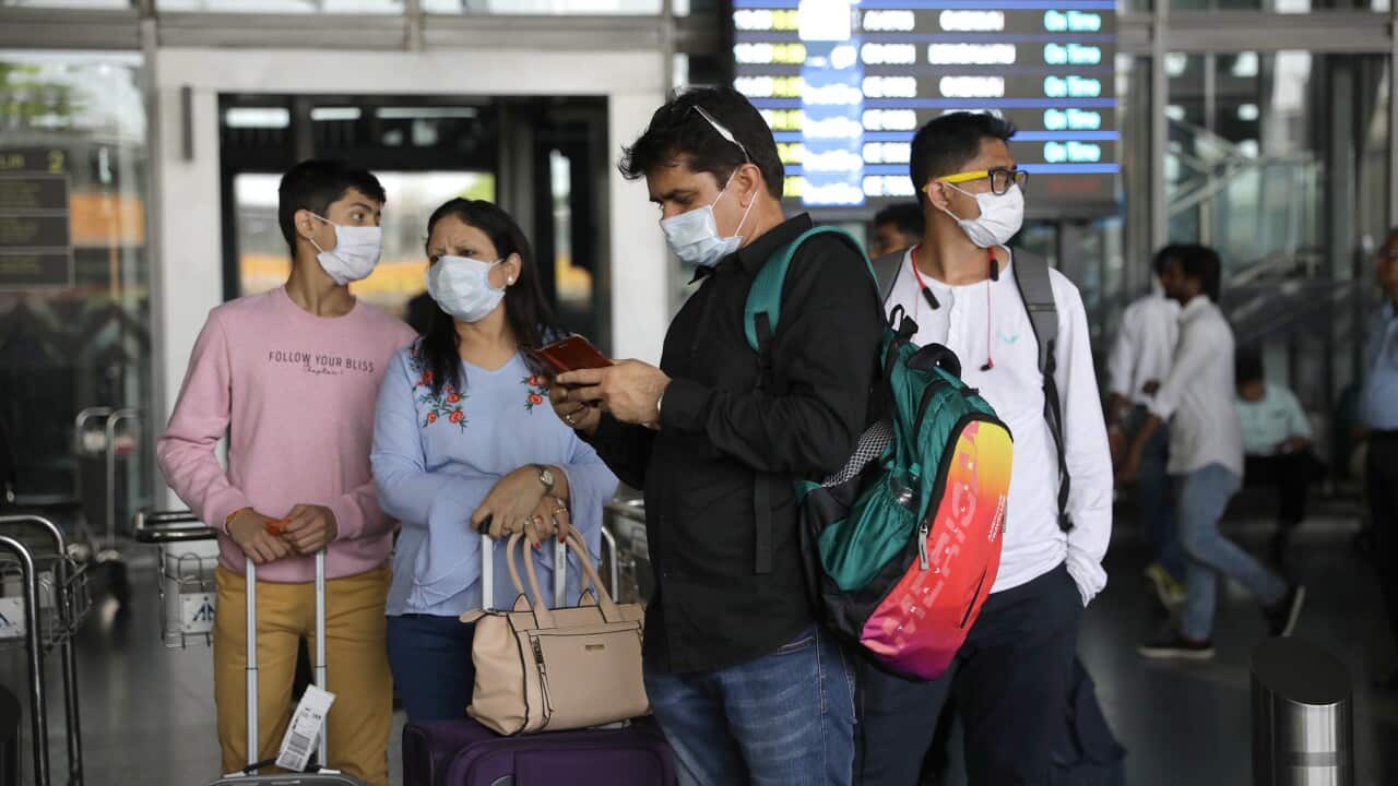 Passengers use protective masks at Netaji Subhash Chandra Bose International Airport in Kolkata, Eastern India, 13 March 2020.