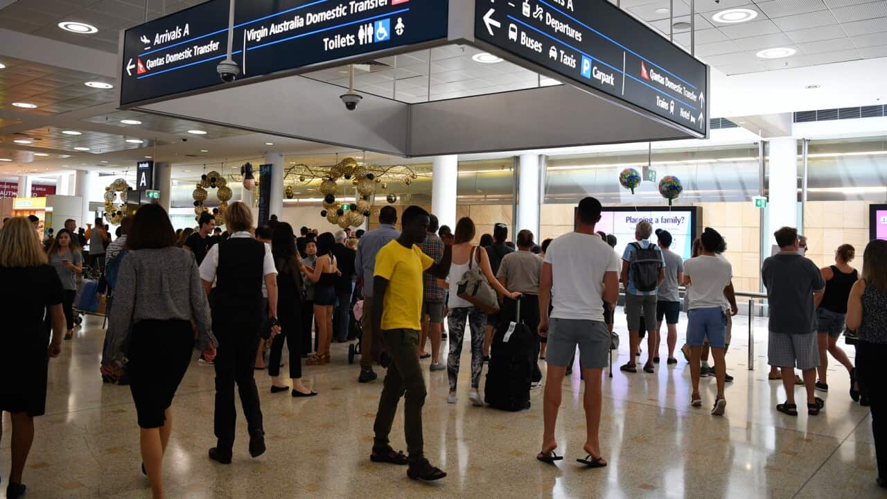 Travellers are seen at Overseas Arrivals and Departures at Sydney's International Airport