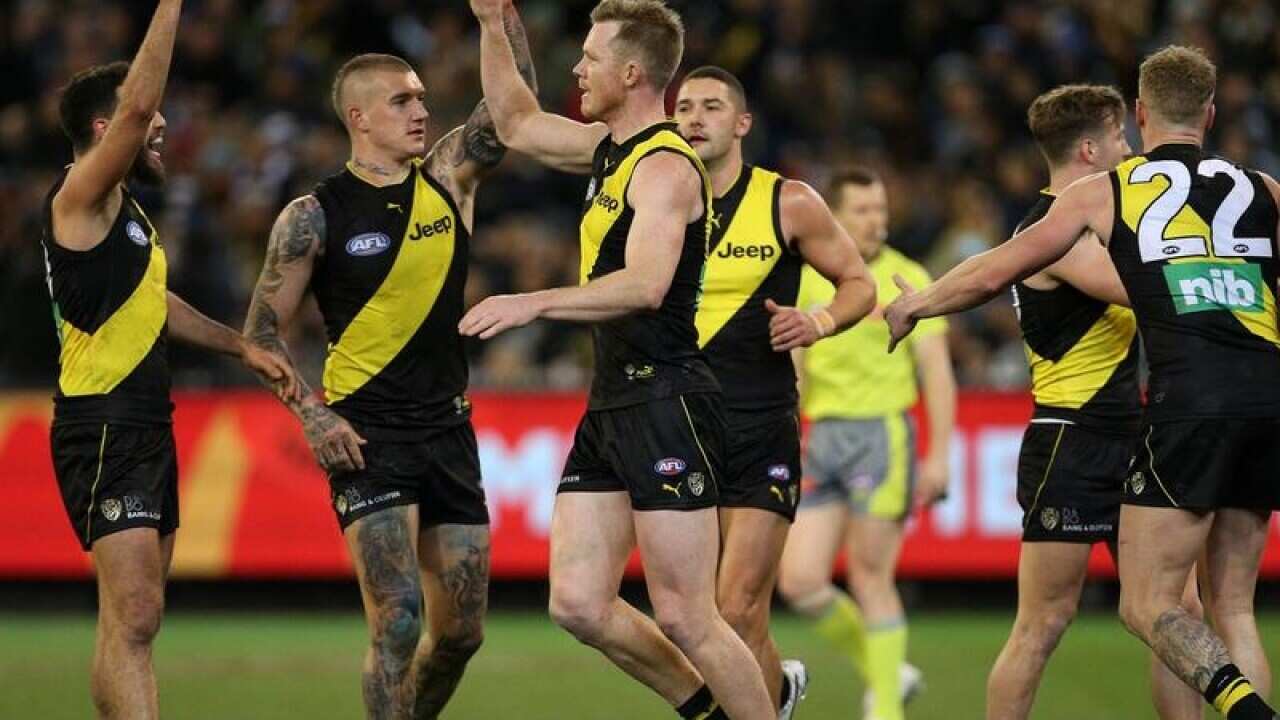 Jack Riewoldt of the Tigers (centre) celebrates after kicking a goal