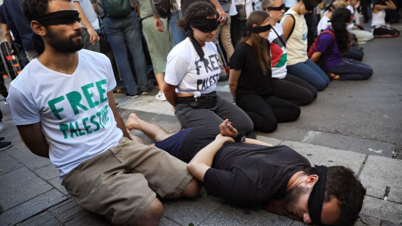 Peace activists protest before the presentation of the 2019 Eurovision Song Contest participants in Tel Aviv, Israel, Sunday, May 12, 2019. (AP Photo/Oded Balilty)