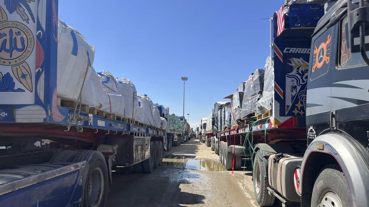 Trucks carrying aid wait to cross into Gaza (AAP).