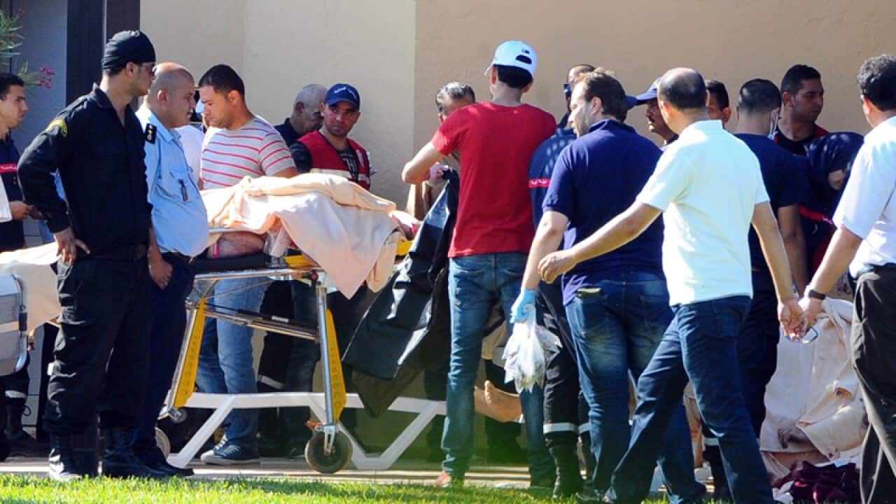 Injured people are treated where an attack took place in Tunisia