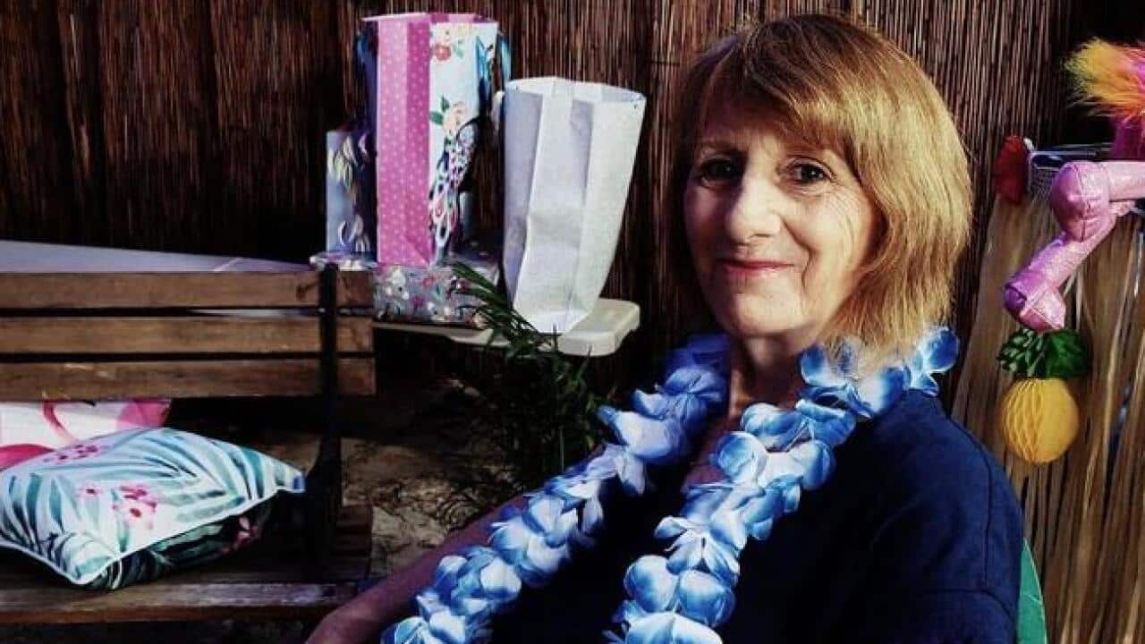 A woman with a tropical flower necklace