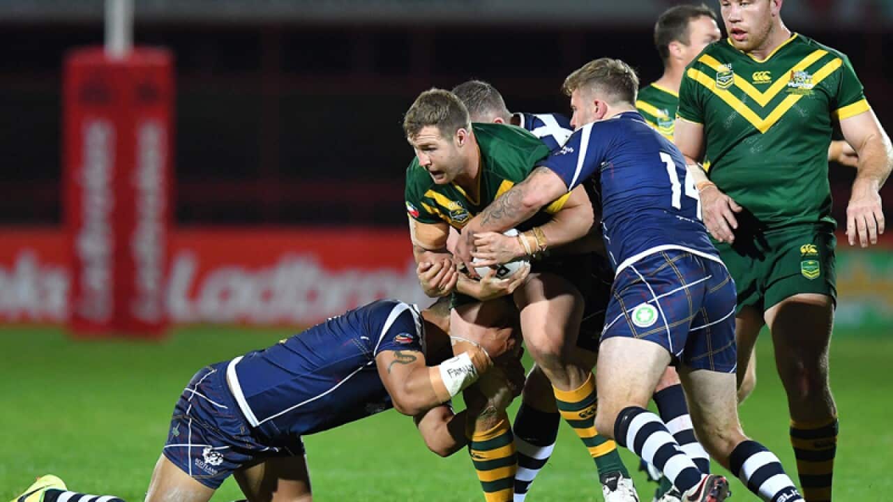 Trent Merrin is tackled during the Four Nations rugby league