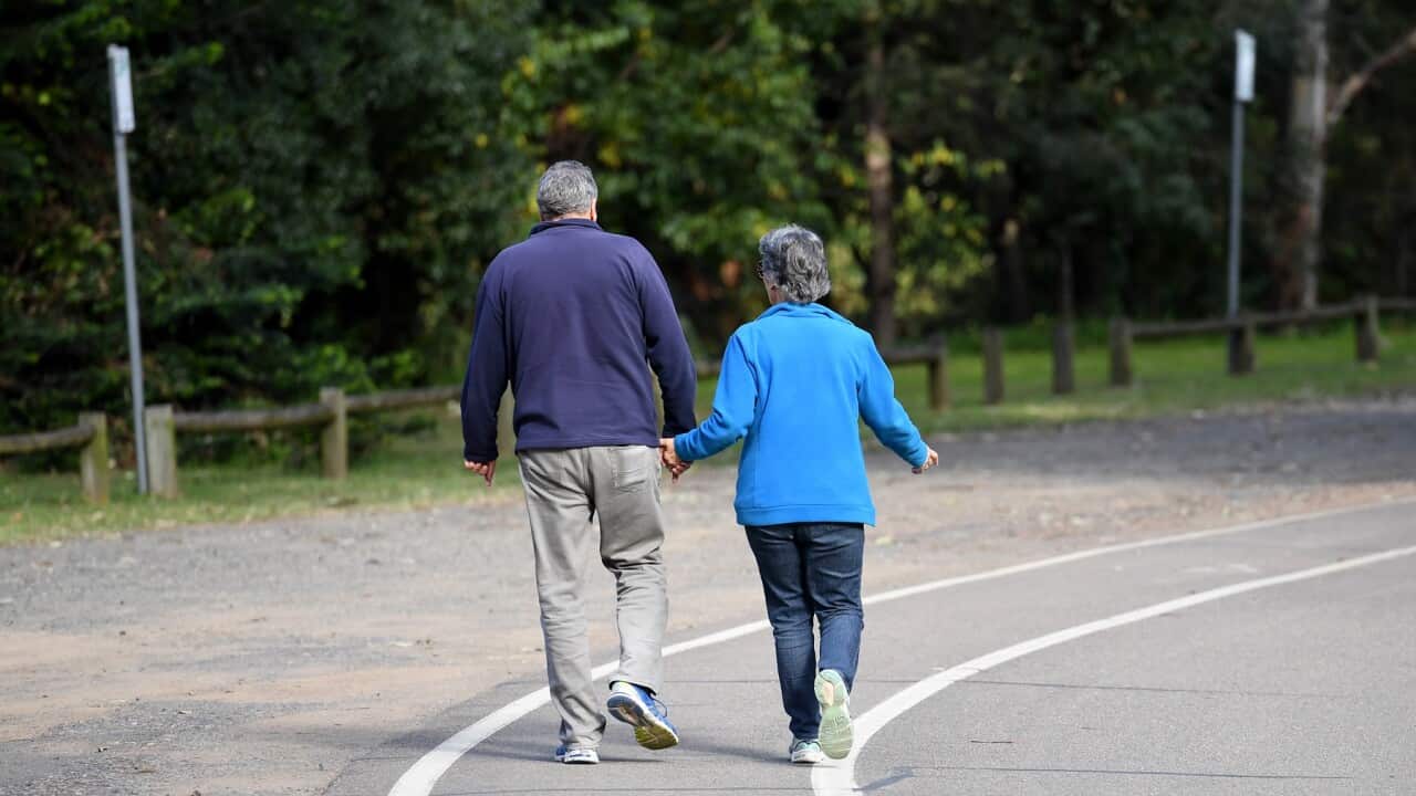 An older couple walking through a park in Sydney (AAP).