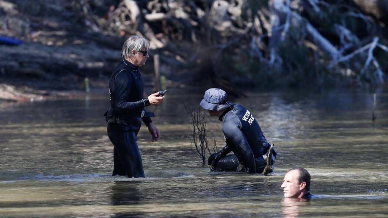 Victorian Emergency services personnel search the Murray River