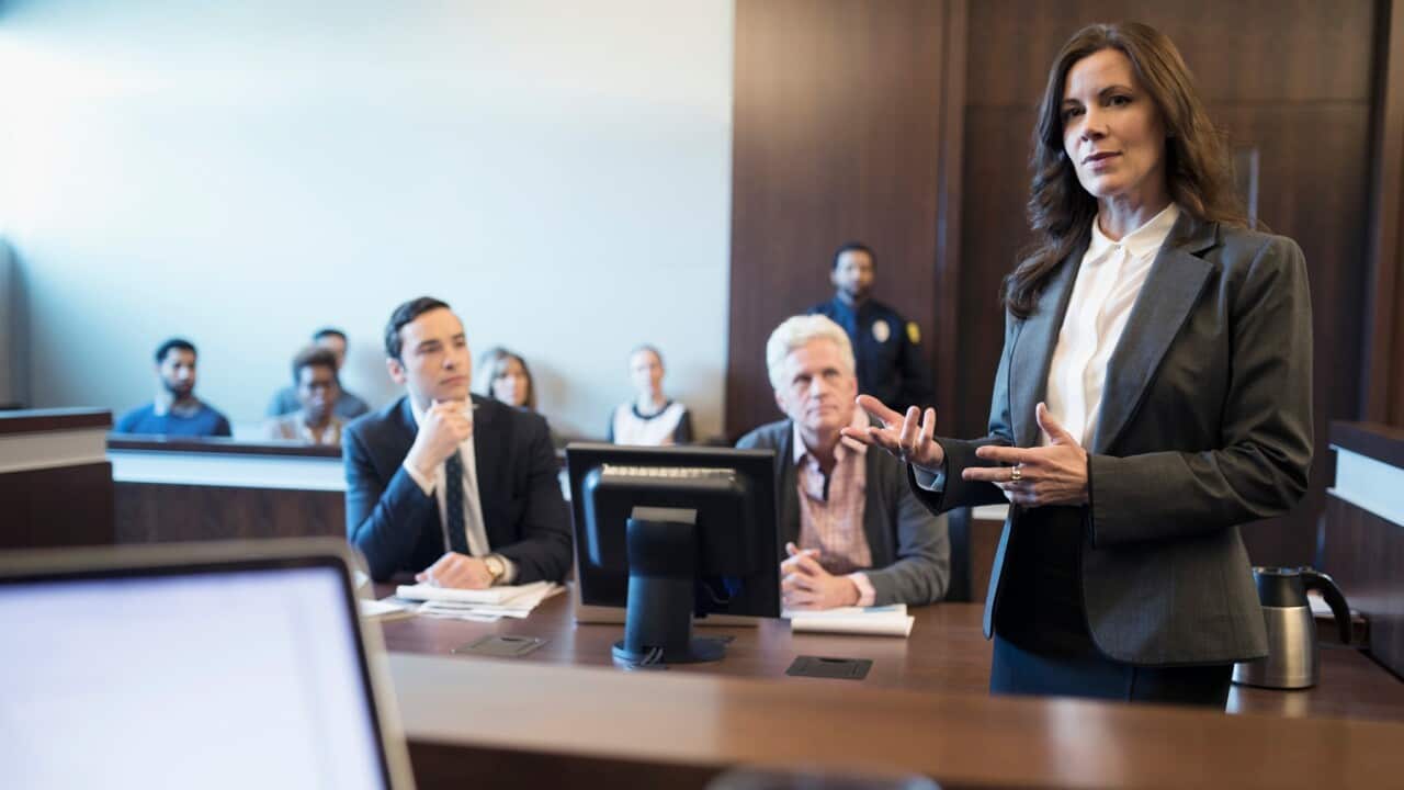 A woman speaking during a courtroom trial