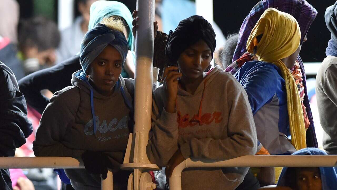 Migrants wait to disembark from the Migrant Offshore Aid Station (MOAS) ship Phoenix in the Sicilian port town of Augusta, Italy, Sunday, June 7, 2015 (AP Photo/Carmelo Imbesi)