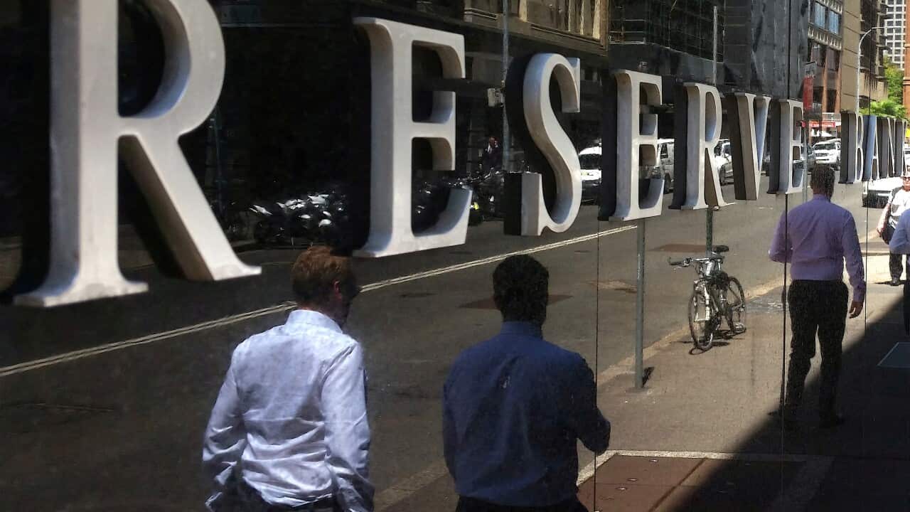 FILE PHOTO: Pedestrians walk past the Reserve Bank of Australia building in central Sydney