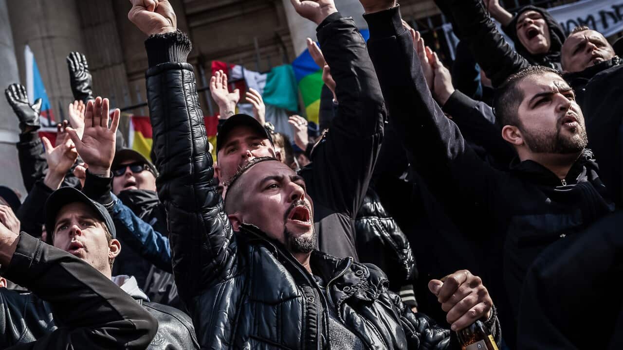 Demonstrators protest at a memorial site at the Place de la Bourse in Brussels (AAP)