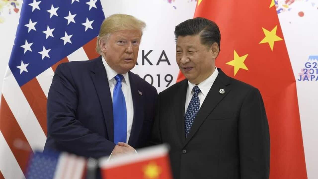 Donald Trump poses for a photo with Chinese President Xi Jinping